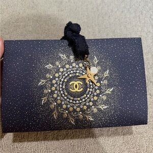 Chanel holiday package wrap with ribbon and pendant